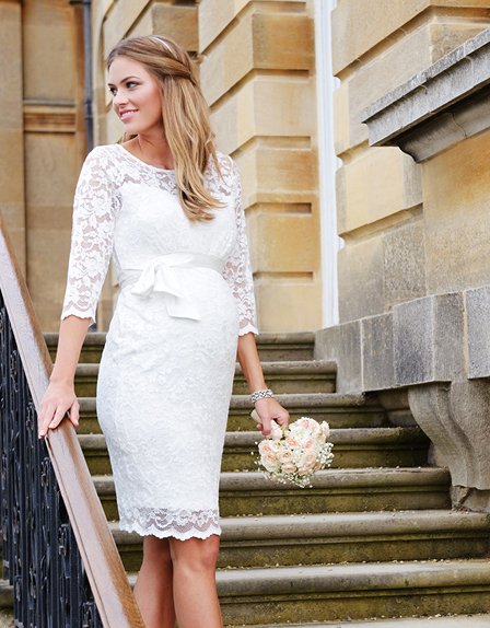 Bride wears lace maternity wedding dress by Seraphine