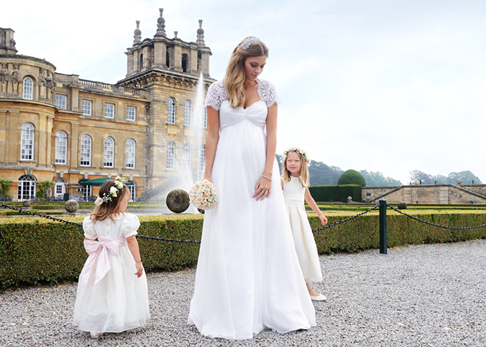 Pregnant bride with flower girls outside Blenheim Palace