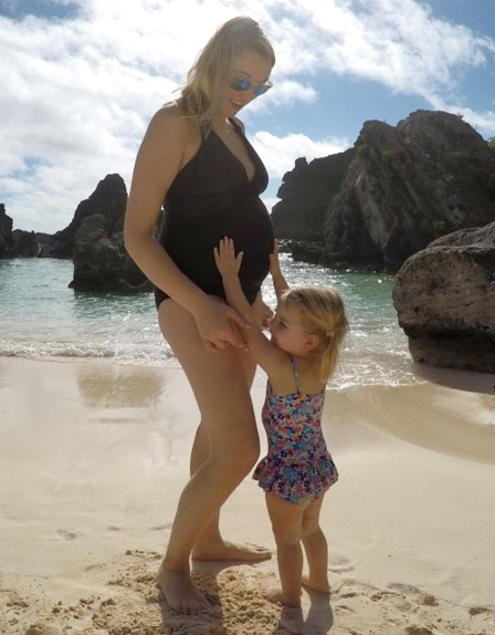 Traveling with baby. Karen Edwards - Travel Mad Mum wears a black maternity swimsuit by Seraphine