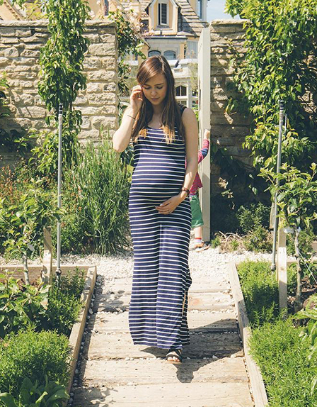 Hannah Maggs wearing a Seraphine maternity maxi dress
