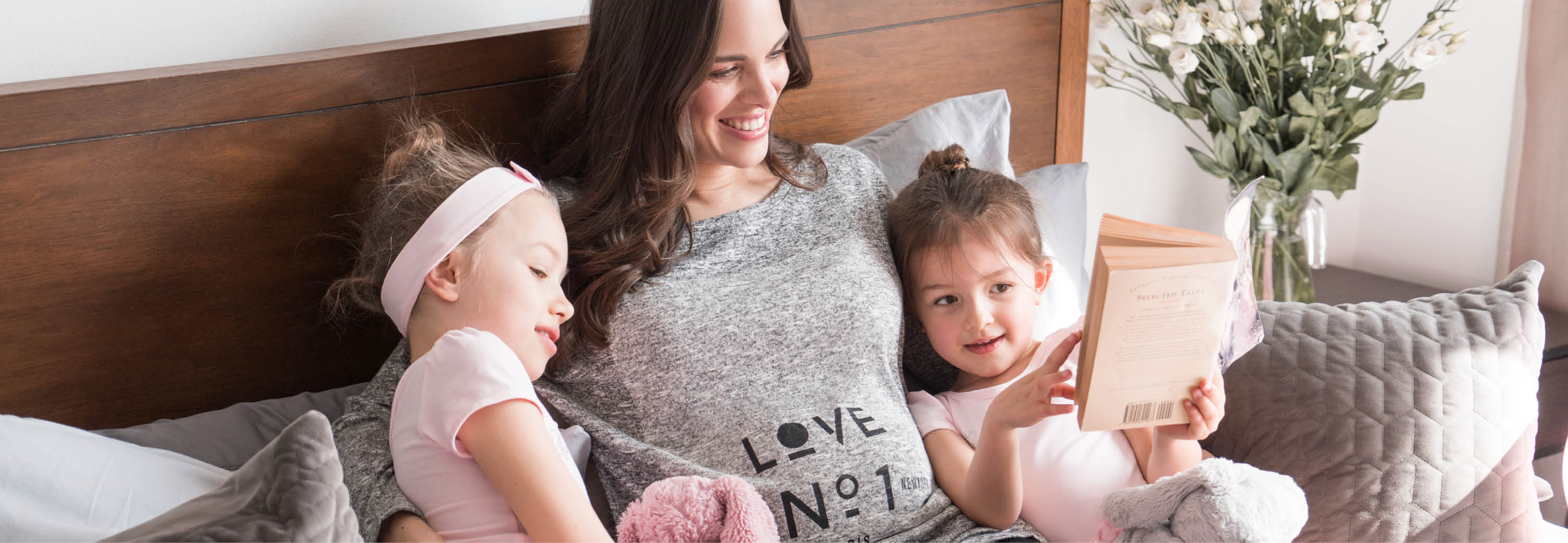 Mum & daughters read pregnancy books together