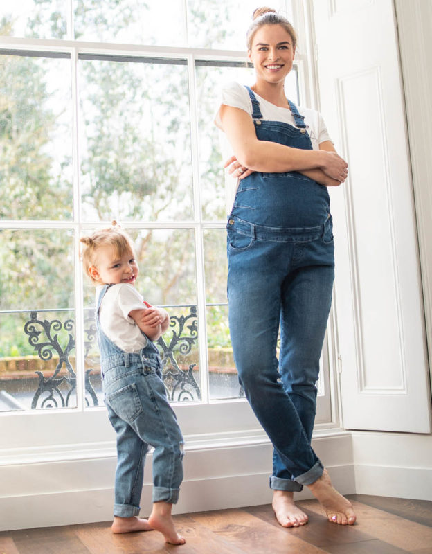 pregnant mum wears maternity dungarees, matching with her toddler toddler